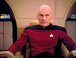 a photo of Captain Picard from Star Trek: The Next Generation sitting in his chair on the bridge